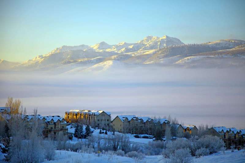 Eden, covered here with fog and mountains looming above, is one of six small Utah towns covered in this article